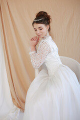 girl in a white wedding retro dress. wedding dress and hairstyle in the style of the 90's. Studio photo shoot in my mother's wedding dress. Bride photo shoot in the studio