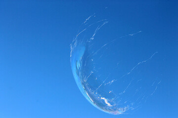 soap bubble burst against a clear sky