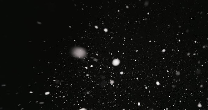 White snow falling against dark background 60fps footage
