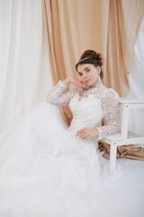 girl in a white wedding retro dress. wedding dress and hairstyle in the style of the 90's. Studio photo shoot in my mother's wedding dress. Bride photo shoot in the studio