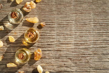 Wooden background with aromatherapy essential oils and frankincense or boswellia