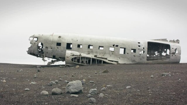 Dolly shot of the abandoned plane wreck dc3 on black vulcanic beach in S&oacute;lheimasandur, Iceland