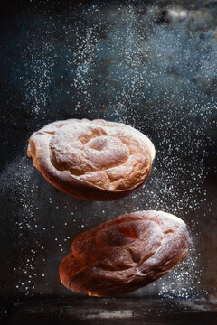 Powdered sugar sprinkling on ensaimadas