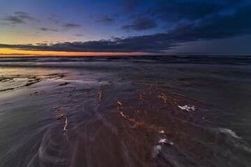 Beach sunrise or sunset over the tropical sea and sky with clouds