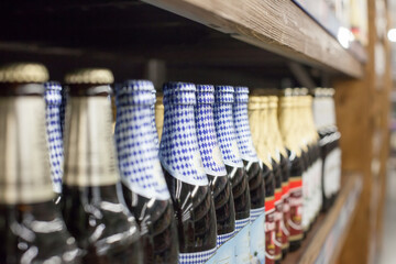Bottles of beer on wooden shelves in   supermarket