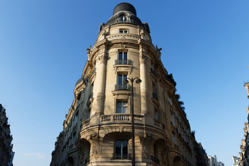 Fototapeta premium The facade of traditional French house with typical balconies and windows. Paris.