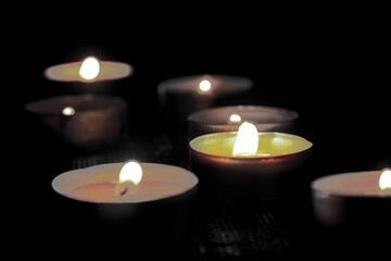 Many burning candles with shallow depth of field. The concept of mourn, grief or mourning.