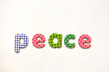 the word peace composed of colorful letters on white background