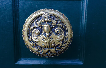 Obraz na płótnie Canvas European Vintage old metal wrought iron door knocker. Design detail. Paris.
