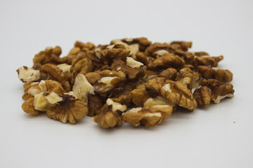 Peeled walnuts on white background