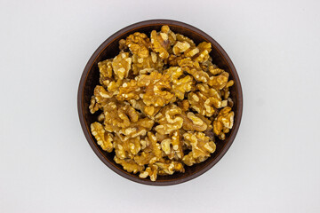 Peeled walnuts in brown plate