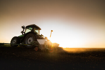 Farmer with tractor seeding