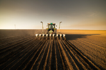 Farmer with tractor seeding