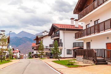 Traditional chalet houses and hotels in Rosa Khutor resort. Mountain Olympic village in the Caucasus Mountains.