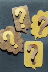 Question mark on speech bubbles, gray background.