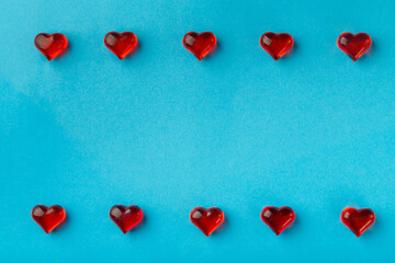 Frame for Valentine's Day with hearts on a blue background around the edges.