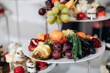 Luxury catering. Delicious fruits and desserts sweet on table at wedding reception in restaurant