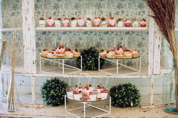 Vintage delicious and tasty dessert table with cupcakes