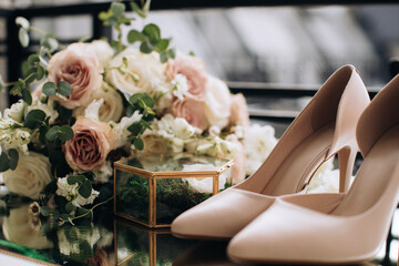 Bride's wedding bouquet of roses and shoes. Wedding accessories