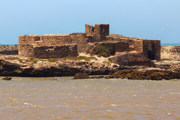 View of the small island with ruins of the ancient fortress near the Atlantic coast in the...