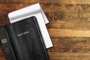 Holy bible with note book on table for christian devotion
