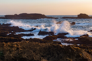 View of the volcanic shore of the Atlantic Ocean in the area of the city of Essaouira in Morocco on a summer evening.