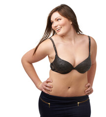 Fototapeta premium She loves who she is. A plump beauty working her curves on an isolated background.