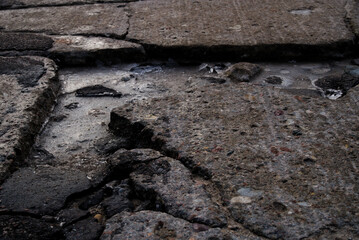 Gap and cracks in the road in winter
