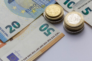 Money as background, euro coins and banknotes on white background. Money and financial concepts, banner, cover, mockup, for your design
