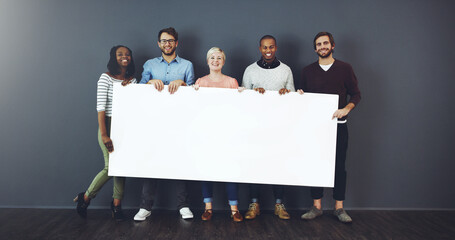 Weve got something for you.... Studio shot of a diverse group of people holding a blank placard...