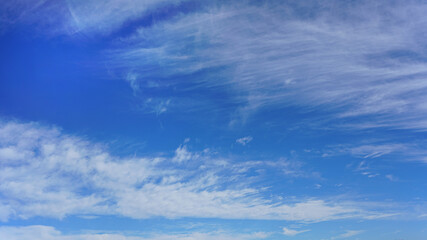 White clouds and blue sky suitable for background or sky replacement.