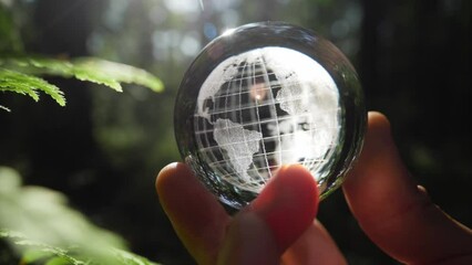 glass globe in human hands, green background. peace in world concept, no war, we need peace. - Powered by Adobe