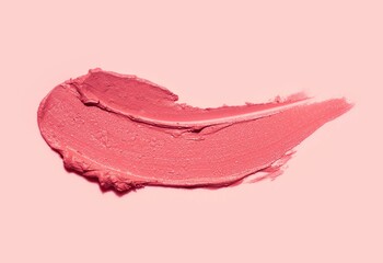 Lipstick abstract strokes smudges background texture multi colored red peach blush isolated on nude pink background