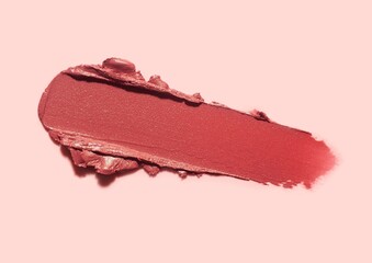 Lipstick abstract strokes smudges  background texture multi colored red ruby garnet brick isolated on beige background