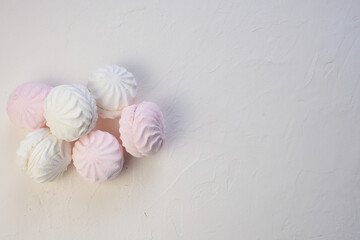 Marshmallow without packaging close-up on a white background. view from above. Zephyr pink and white. Protein sweetness. Air dessert.
