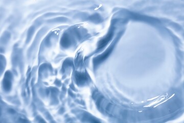 Splash cosmetic moisturizer water micellar toner or emulsion blue colored abstract background