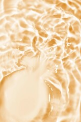 Splash cosmetic moisturizer water micellar toner or emulsion orange yellow colored abstract background