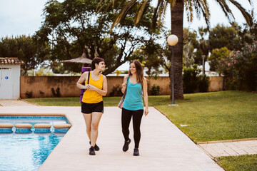 Two real women going out to train together outdoors to lead a healthy life