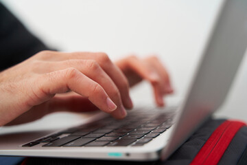Detail of hands working on laptop