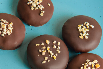homemade  chocolate sweets with pumpkin and orange  in a blue dish , close-up
