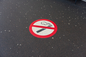 Smoking prohibited sign painted on asphalt.