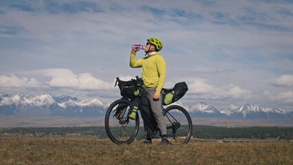 The man travel on mixed terrain cycle touring with bikepacking. The traveler journey with bicycle...