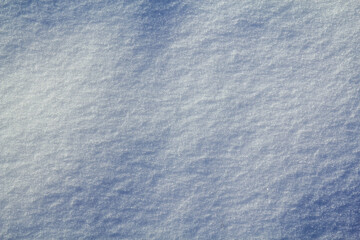 Background in the form of a wavy surface of snow in a field in natural daylight.