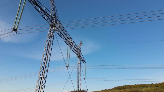 High voltage insulation string on steel pillar with electric power lines for safe delivering of electrical energy through cable wires on long distance
