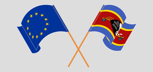 Crossed and waving flags of the European Union and Eswatini