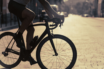 Fototapeta na wymiar Close up of cyclist riding bike on empty city street