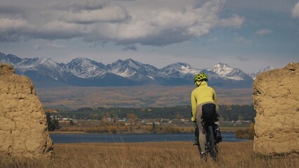 The woman travel on mixed terrain cycle touring with bikepacking. The traveler journey with bicycle...