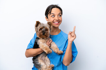 Young veterinarian woman with dog isolated on white background intending to realizes the solution while lifting a finger up