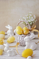 basket with colorful easter eggs and spring flowers