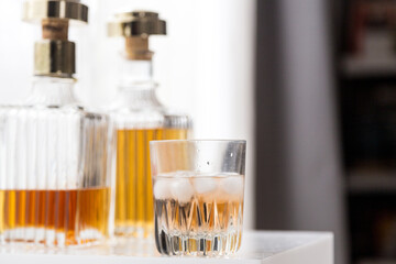 Fototapeta na wymiar Luxury glass bottles with different alcoholic spirits inside, copy space photo